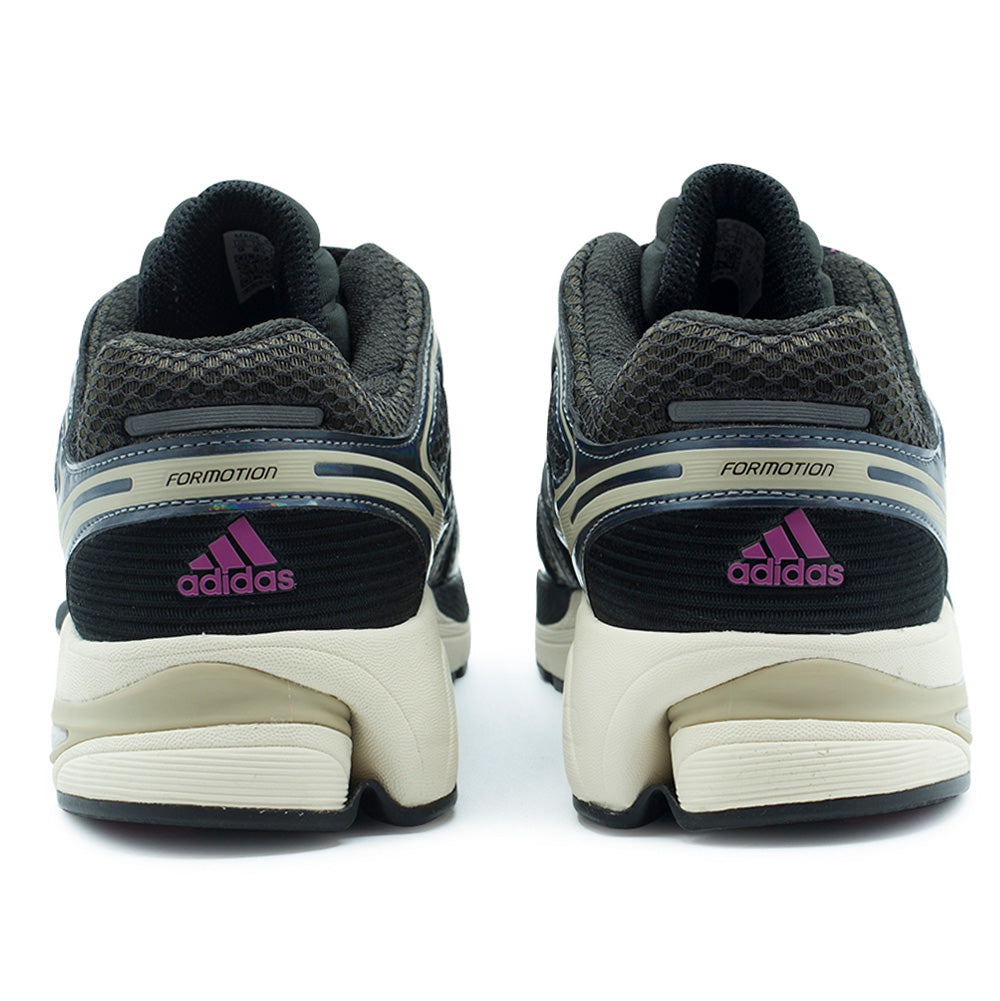 Rear studio perspective of the adidas Adistar Control 5 heel structure, displaying the thick padded black collar lining, arched Formotion chassis support frames, textured black ribbed heel panels with hot pink adidas mountain logo badges, and separated dual-density cream and khaki foam midsoles.