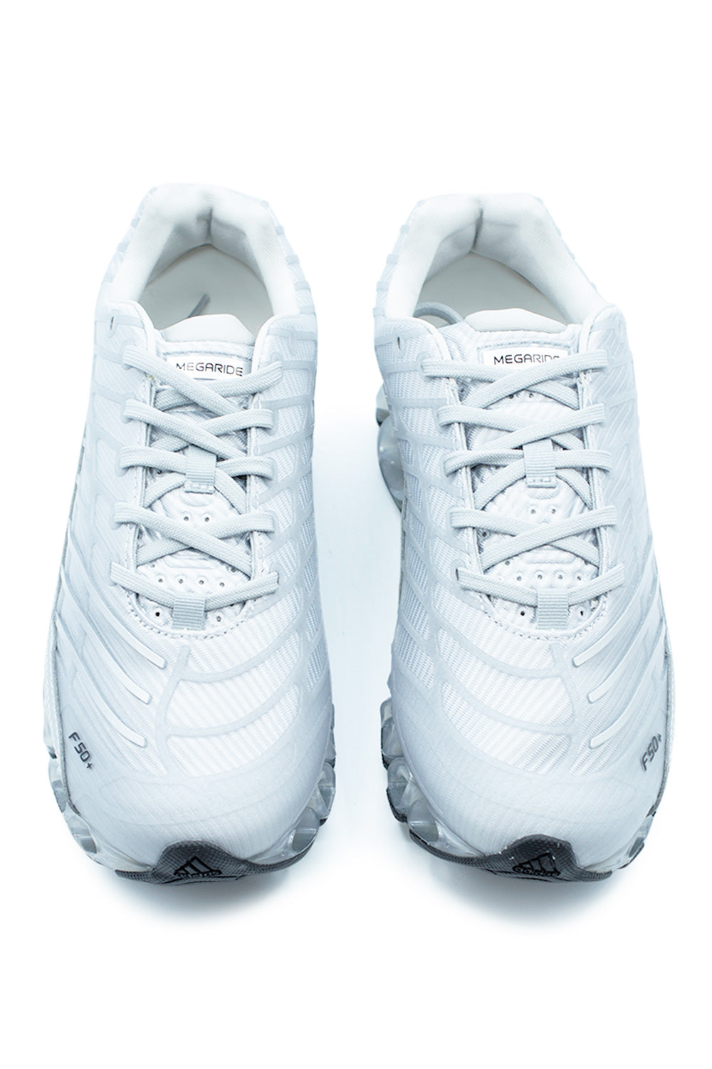 Front view of Adidas Megaride F50 performance sneaker in metallic silver showing breathable mesh construction, precision lacing system, F50+ branding and lightweight technical build.