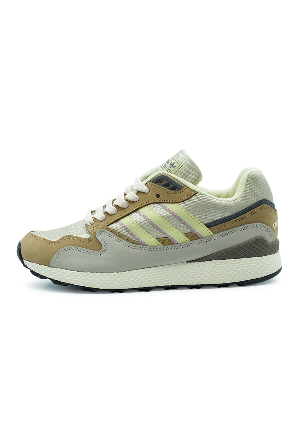 Lateral profile view of the Adidas Oregon Ultra Tech sneaker in Tech Met, Dual Yellow, and Cardboard, highlighting the textured ribbed cream mesh base, tan and light grey premium nubuck overlays, pastel yellow three stripes with muted lilac underlay borders, and the signature white cross-hatched Dellinger web netting wrapping the EVA midsole