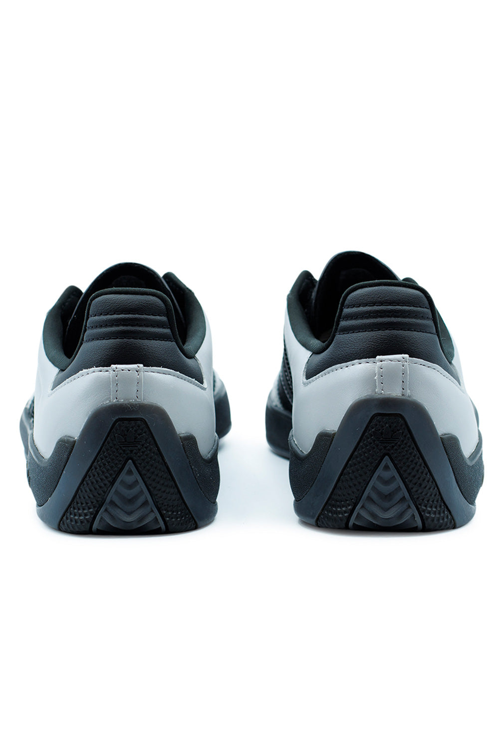 Rear angle of Adidas Puig Samba shoes showing structured heel counter, black outsole traction design and reinforced skate-ready construction for grip and stability