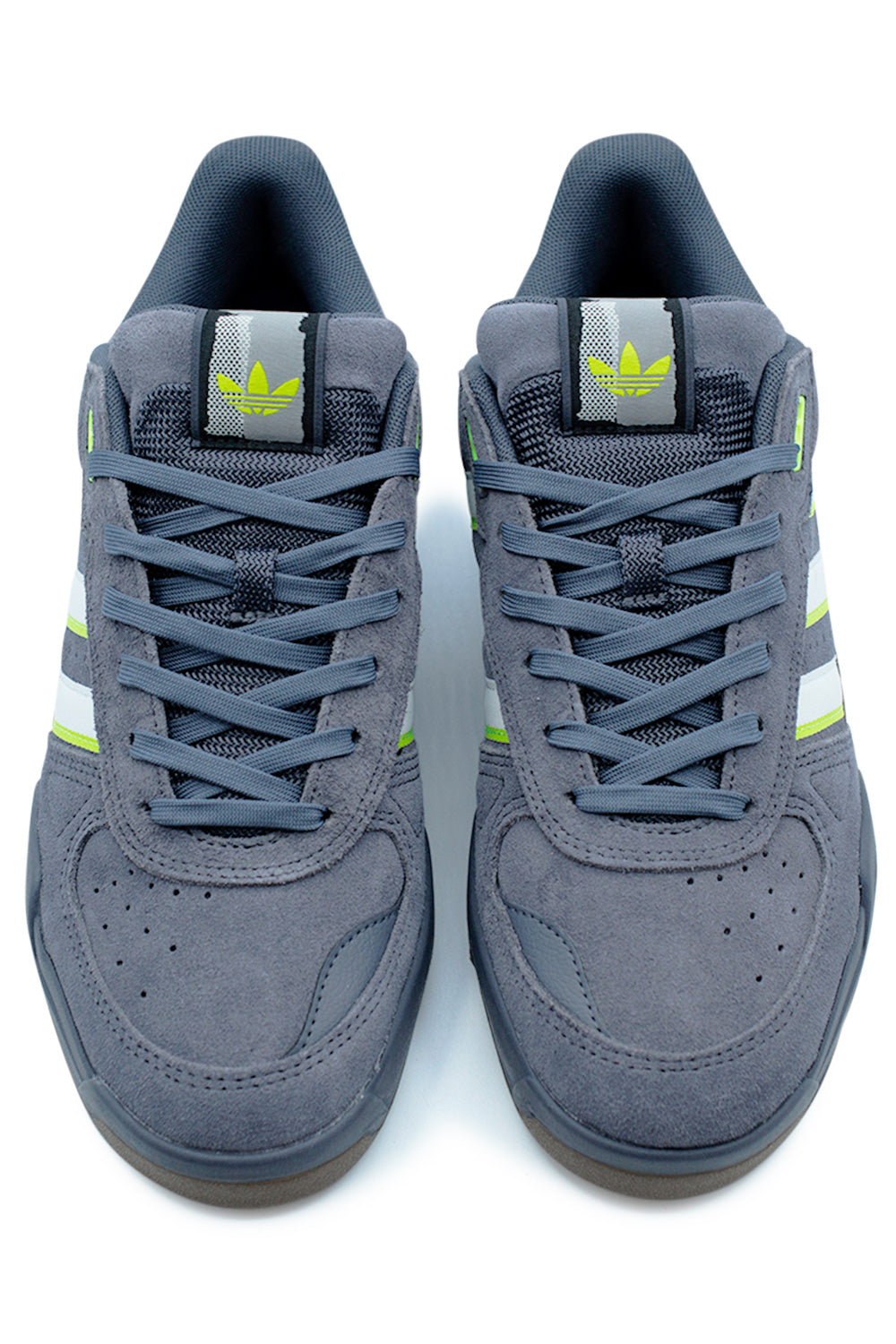 Close-up of Adidas Tekkira Cup tongue and lacing system with neon green Solar Slime details and grey suede.