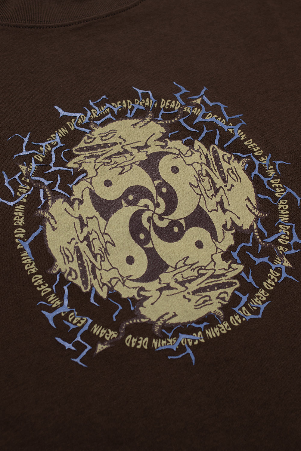 Close-up of Brain Dead Ying Yang Run T-Shirt Brown showing detailed raised chest print with yin yang artwork and signature Brain Dead graphic elements on premium brown cotton streetwear T-shirt