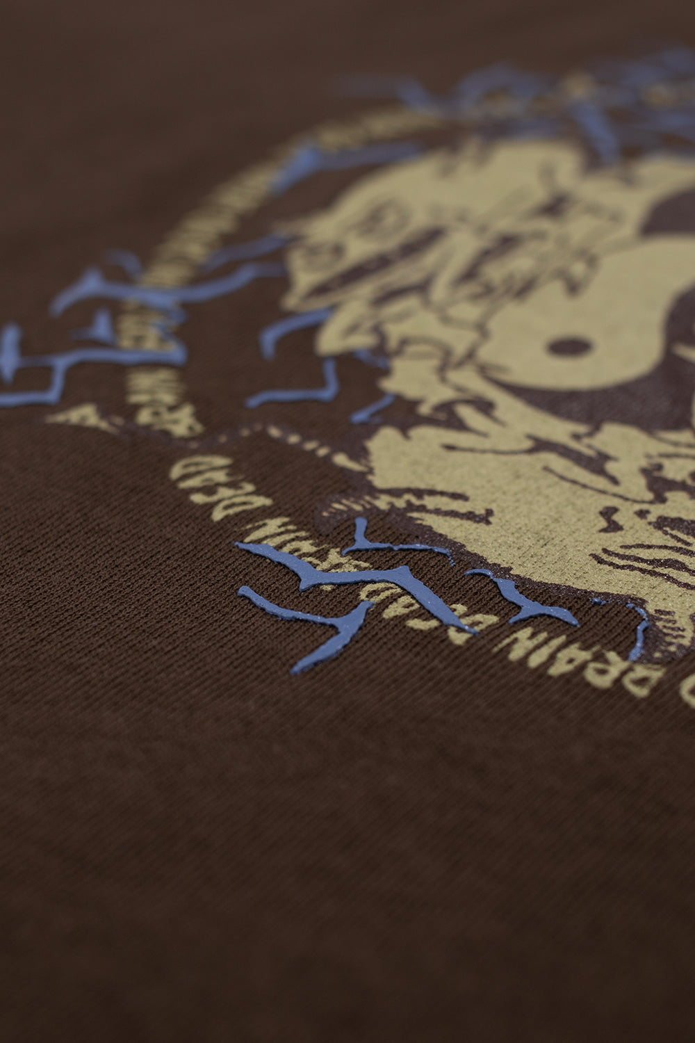 Macro fabric detail of Brain Dead Ying Yang Run T-Shirt Brown highlighting textured raised graphic print and heavyweight cotton jersey material used in this Brain Dead Los Angeles graphic tee made in Portugal