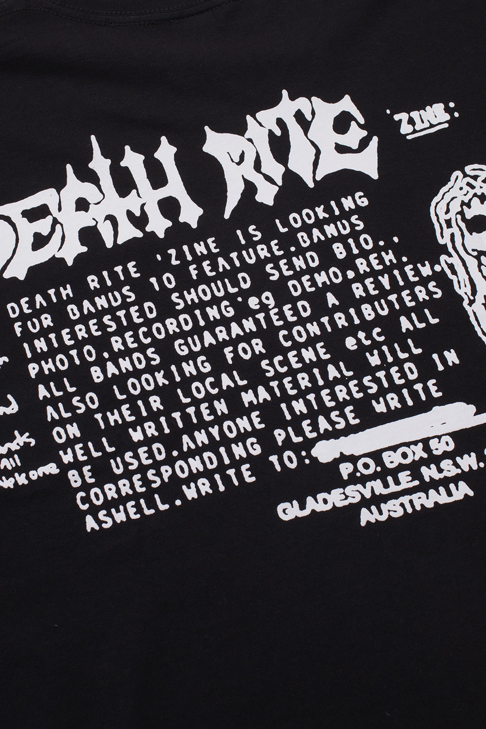 Close-up detail of the white printed fanzine text and classified ad design on the back of the black Death Rites heavy cotton t-shirt.