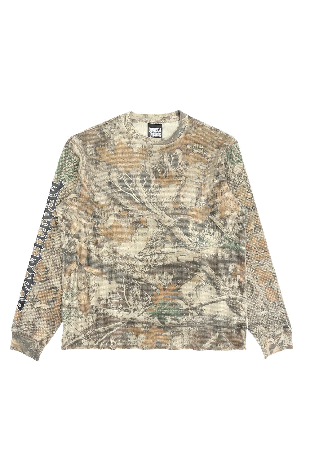 Full front view of the loose-fitted Death Rites waffle knit crewneck long sleeve top, featuring an all-over tree camo pattern and a black metal-style script logo printed on the right sleeve.