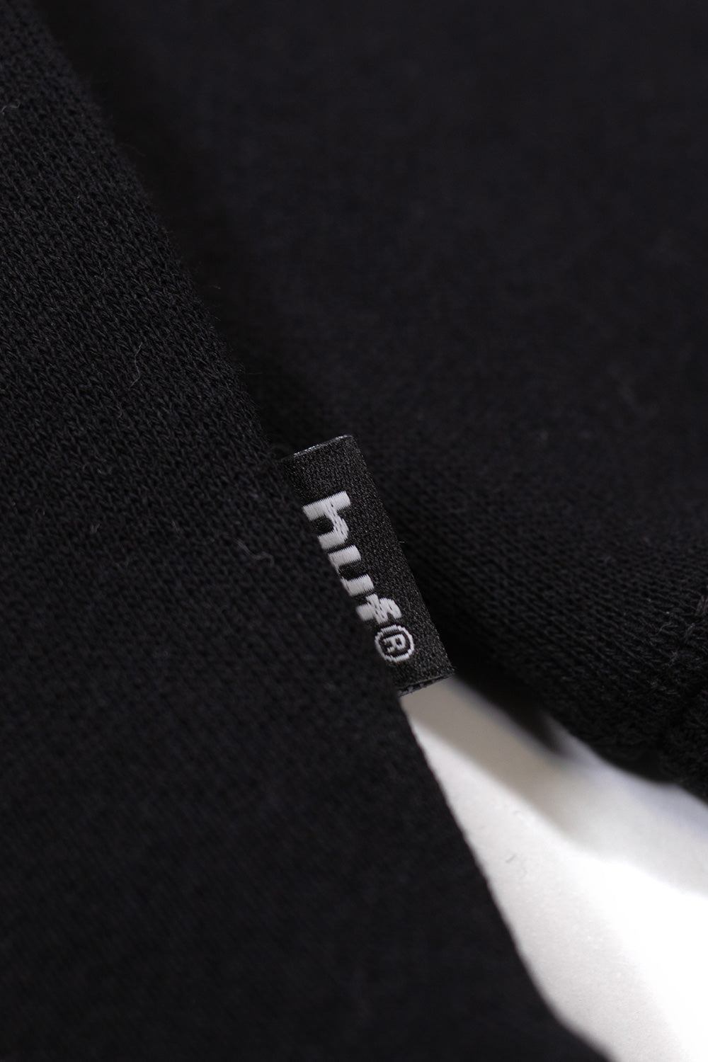 Close-up of HUF x Metal Gear Solid hoodie artwork, showcasing collage-style illustration, bold graphic print, and premium heavyweight fleece construction
