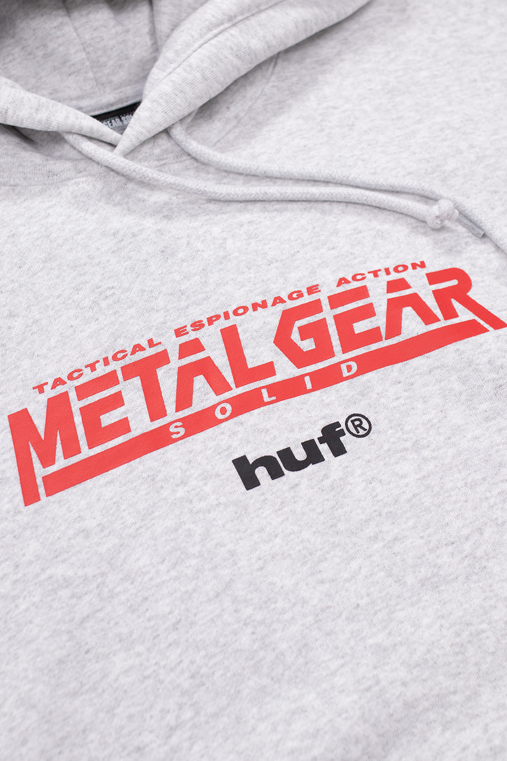 HUF x Metal Gear Solid Legacy Collection hoodie showing Solid Snake face graphic, printed chest branding and relaxed fit streetwear design