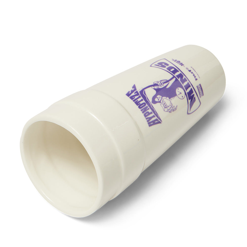 Tilted isometric flat view of the Huf X Three 6 Mafia Ceramic Double Cup lying on a white studio background, displaying the contoured stacked ridges, wide round rim, and the purple screen-printed Hypnotize Minds grim reaper artwork.