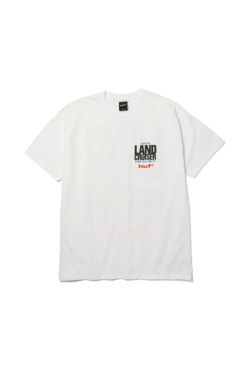 Front flat lay view of the white Huf X Toyota Land Cruiser Rally SS T-Shirt, displaying the relaxed fit crewneck silhouette and a compact left-chest screen print featuring stacked blue "TOYOTA", bold black "LAND CRUISER", blue Japanese Katakana characters, and a red "huf®" logo.