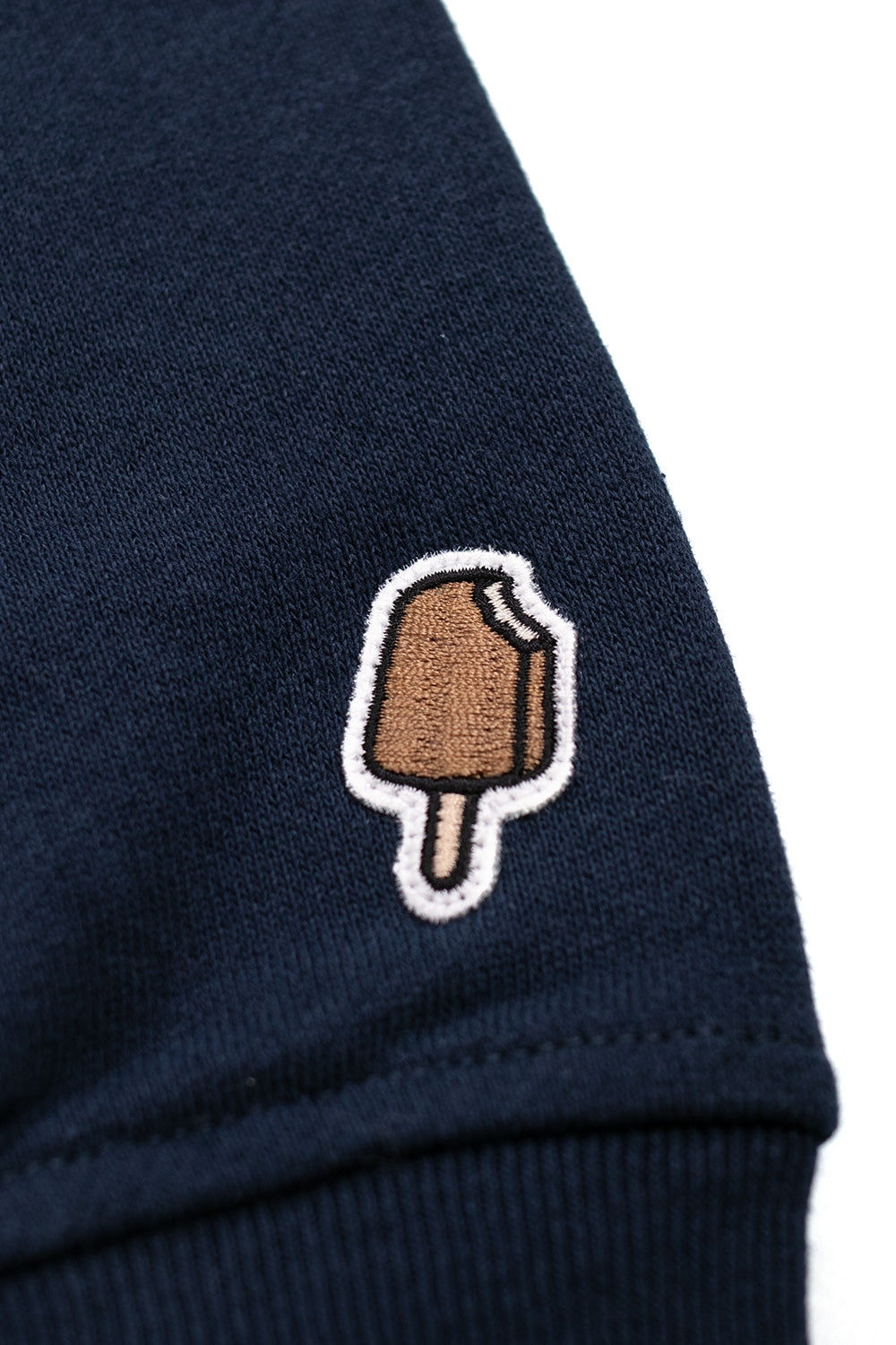 Ice Cream Running Dog popover hood in navy blue featuring a dynamic red print