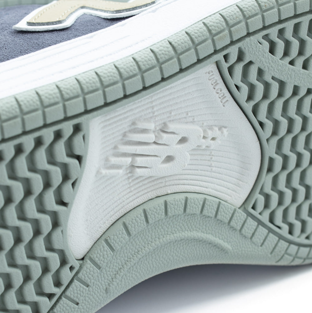 Extreme macro close-up of the arch tread and cupsole sidewall on the New Balance Numeric 480, highlighting the embossed NB# skate logo, debossed "FuelCell" technical cushioning branding, and textured wavy grip tread pattern on the rubber outsole.