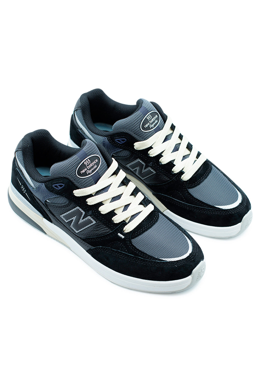 Angled pair of New Balance Numeric 933 Andrew Reynolds skate shoes in black and grey with mixed-material upper and responsive ABZORB cushioning