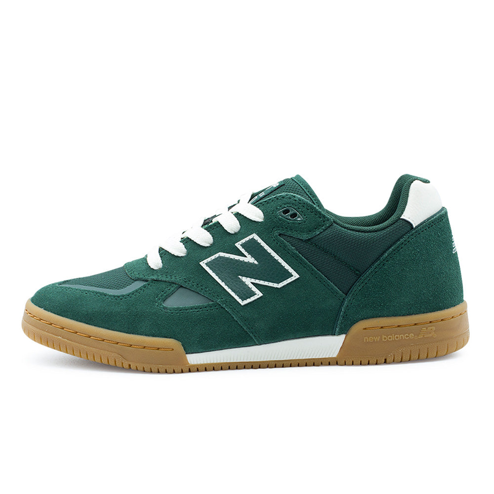 Lateral profile studio view of the New Balance Numeric Tom Knox 600 skate shoe in Nordic Green and White, featuring a low-profile 1990s indoor football-inspired silhouette crafted with deep green suede overlays, breathable mesh underlays, white leather N logo patch, white heel accent, and a stitched gum rubber cupsole with white FuelCell midsole insert.