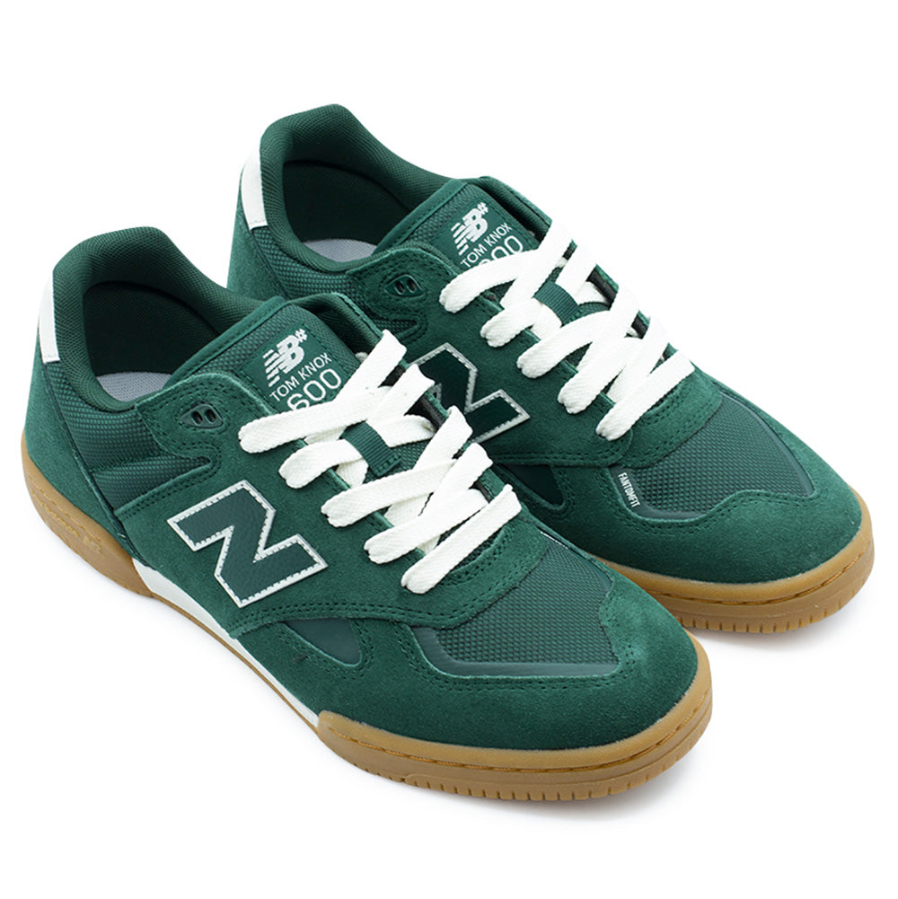 Pair angle studio presentation of the New Balance Numeric Tom Knox 600 sneakers in Nordic Green / White, highlighting the sleek soccer-inspired skate silhouette, durable multi-paneled suede construction, ventilated mesh tongue and quarters, and flexible low-profile gum cupsoles.