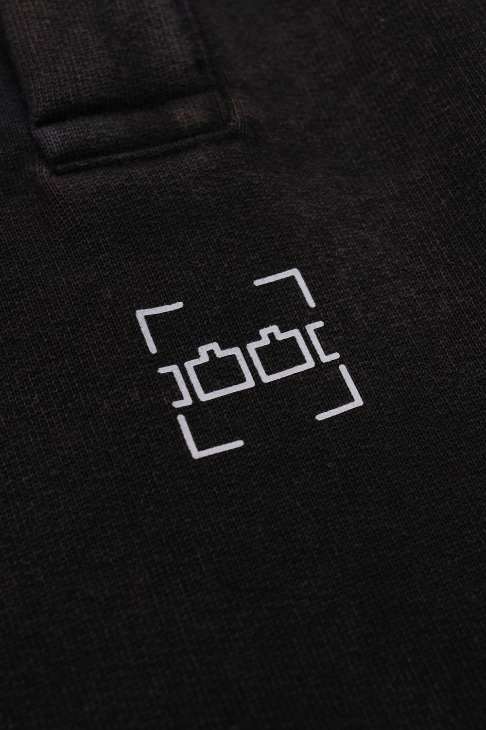 Detailed view of the printed Dash Line chest graphic on the The Trilogy Tapes Black Acid Wash hoodie, featuring vintage washed cotton, premium streetwear craftsmanship, underground London label branding and minimalist graphic design.