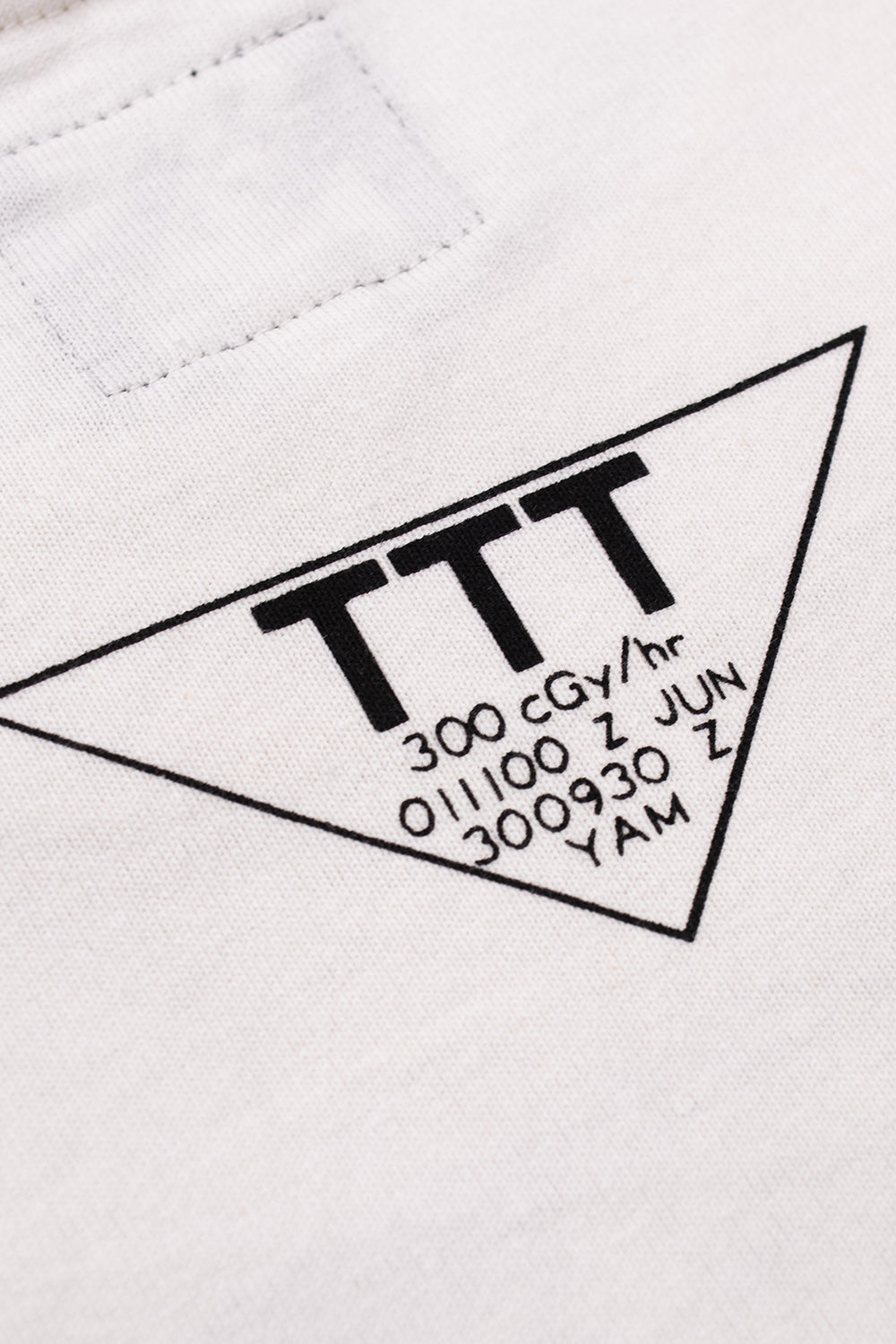 Detailed view of the printed TTT neck graphic on the The Trilogy Tapes Gas Mask Instruction Longsleeve White, emphasizing premium cotton jersey, refined print quality, exclusive branding details and contemporary underground streetwear craftsmanship.