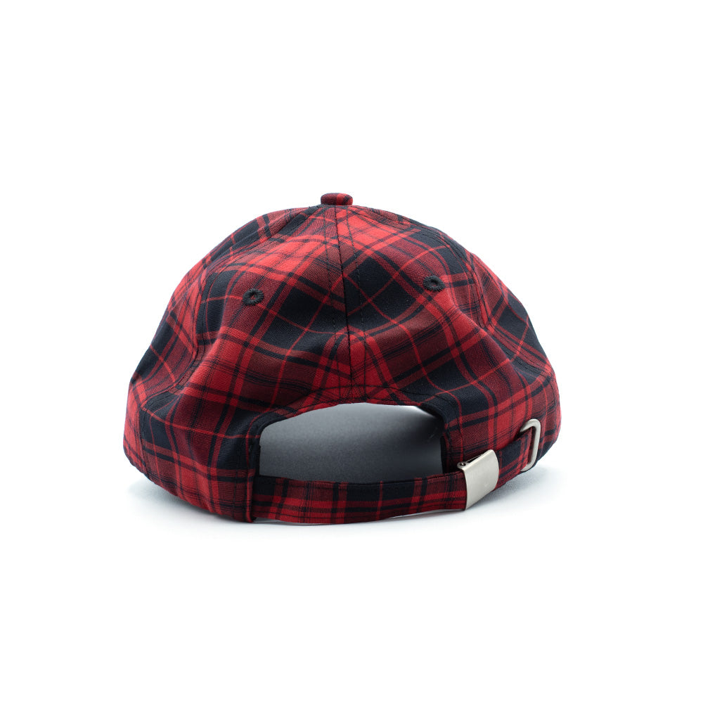 Rear studio perspective of the Token Pissing Angel Cap, displaying the red and black plaid checked pattern across the six-panel crown, sewn eyelets, an arched back opening, and an adjustable matching tartan fabric strap fastened with an antique silver metallic slider clasp.