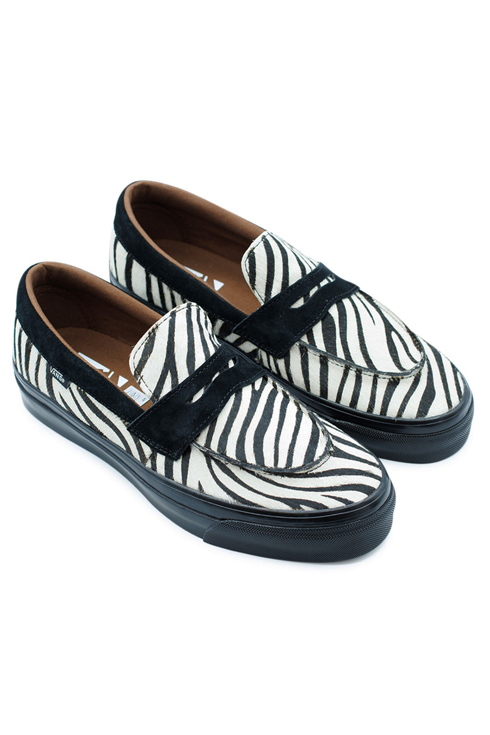 pair of Vans zebra loafers with pony hair texture combining punk-inspired fashion with classic penny loafer silhouette, perfect statement sneaker for modern street style