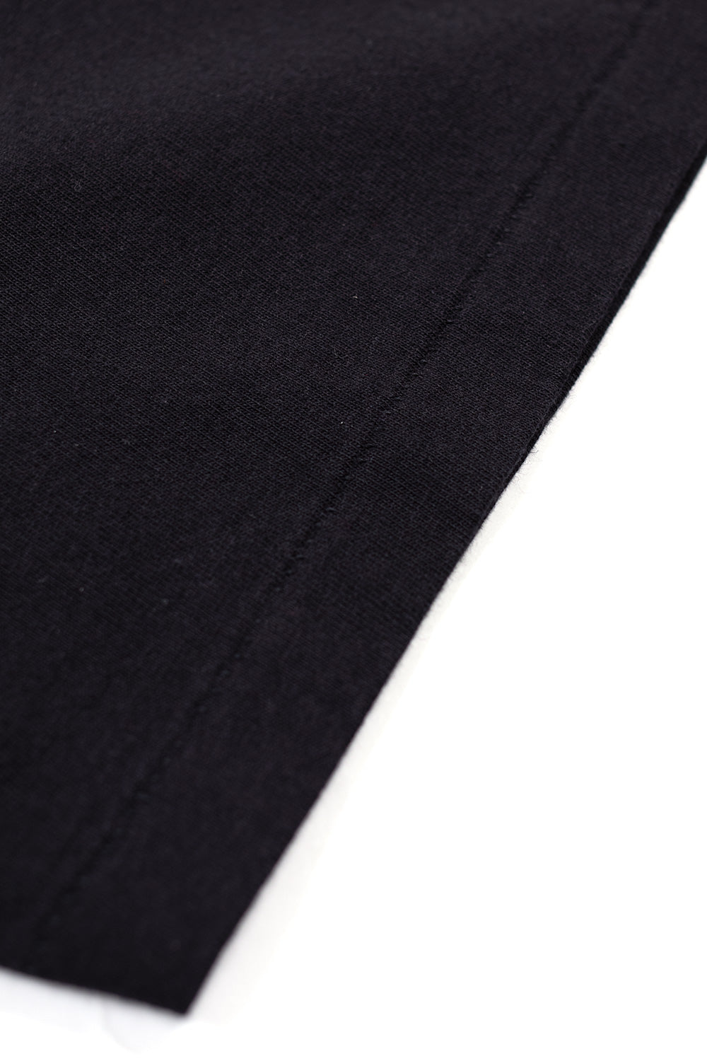 macro view of heavyweight cotton fabric and vintage single stitch seam on Wacko Maria black t-shirt, high quality Japanese construction