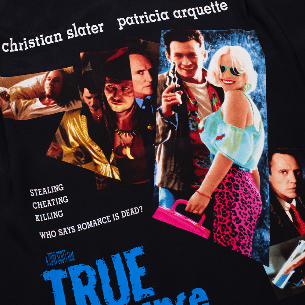 Macro studio view of the back graphic print on the Wacko Maria x True Romance Hawaiian Shirt, detailing the vibrant multi-character collage from Tony Scott's cult film with Alabama Whitman in pink leopard print and Clarence Worley holding a revolver, surrounded by printed movie quotes.