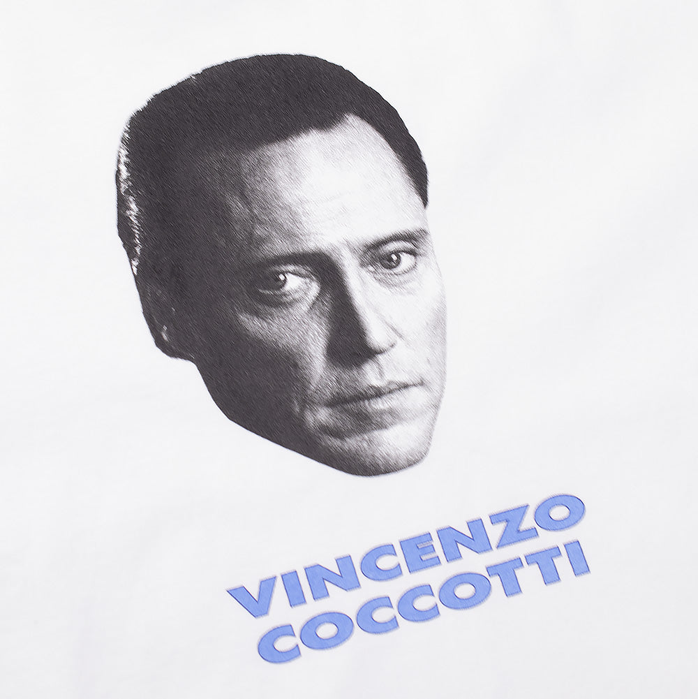 Detailed macro studio close-up of the front chest graphic on the white Wacko Maria x True Romance T-Shirt, highlighting the high-contrast black-and-white halftone portrait of character Vincenzo Coccotti above the powder-blue outlined "VINCENZO COCCOTTI" name lettering on heavy cotton jersey.