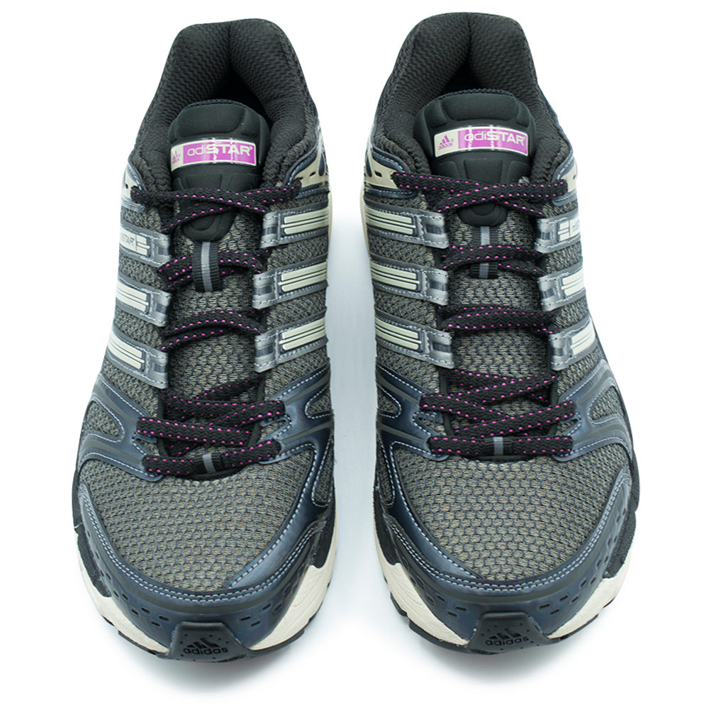 Top-down studio view of the adidas Adistar Control 5 sneakers, highlighting the breathable dark grey mesh vamps, iridescent toe bumpers with micro-perforations, two-tone black and fuchsia rope laces threaded through metallic eyelets, and padded black tongue tabs accented with vibrant fuchsia and white adiSTAR brand labels.