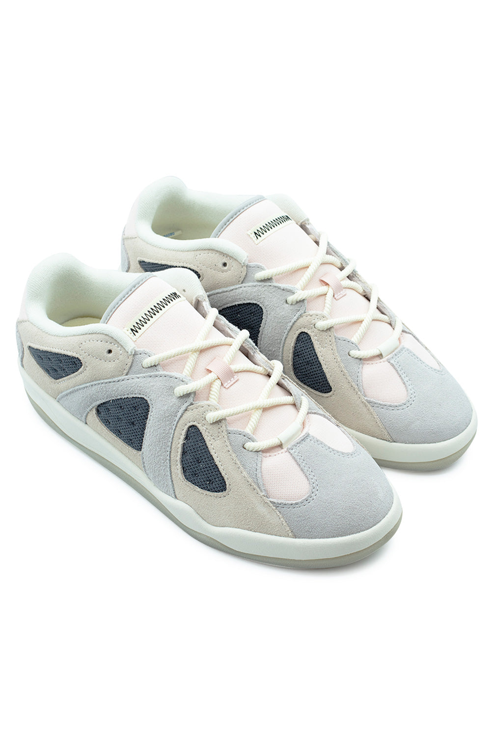 Elevated three-quarter studio angle of the Adidas Bad Bo 1.1 in Chalk White / Grey Two / Pink, capturing the chunky early-2000s skate footwear aesthetic, multi-layered premium suede panels, dark ventilation cutouts, and vintage cupsole profile