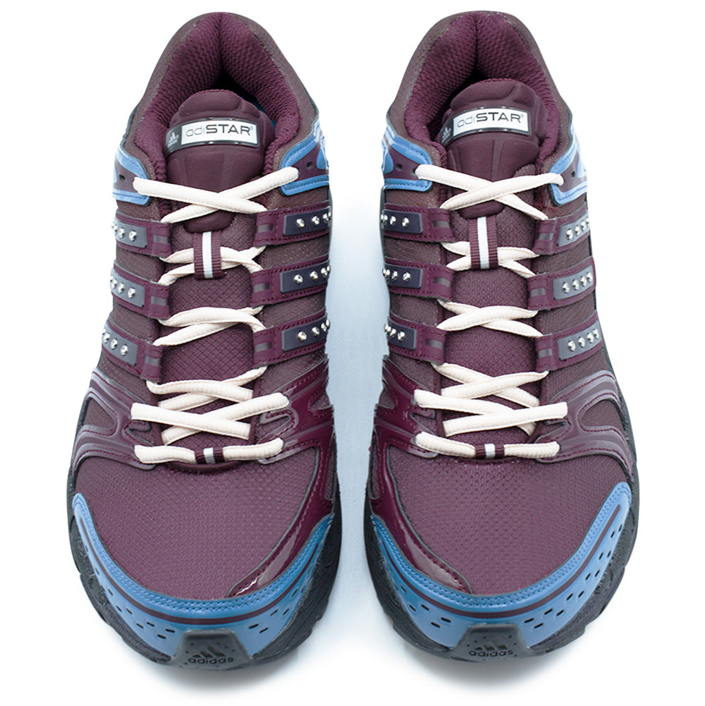 Top-down view of the Adidas X Hardies Adistar Control 5 shoes, displaying the off-white contrast lacing system, glossy maroon eyestay overlays set with silver crystal rhinestones along the stripes, padded mesh tongues with white "adiSTAR" badges, and perforated blue toe cap reinforcements.