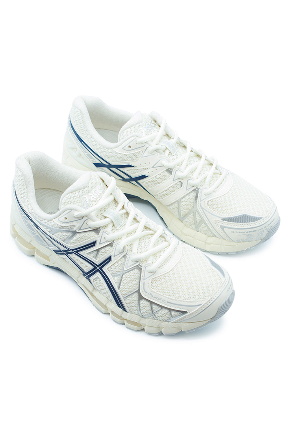 Three-quarter perspective of ASICS GEL-Kayano 20 lifestyle running shoes in cream with navy accents showing layered performance upper, GUIDANCE TRUSSTIC system and classic technical runner silhouette.