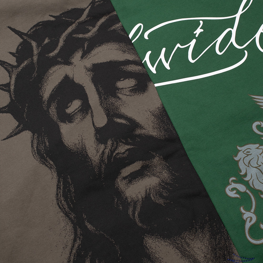 Macro studio view of the split graphic composition on the Born X Raised Mashup Zip-Up Hoodie, capturing the detailed fine-line screen print of Jesus wearing the Crown of Thorns on brown cotton fleece meeting the flowing white cursive "wide" script printed on the dark green side.