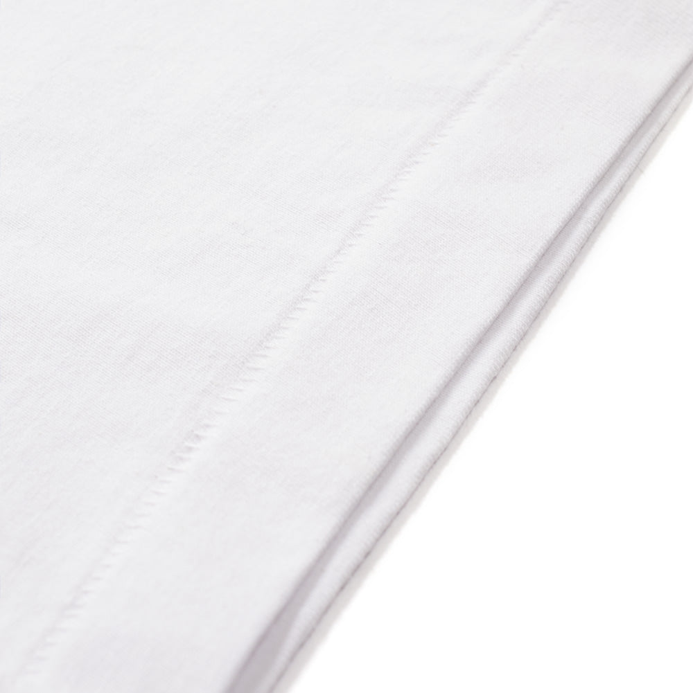 Macro studio perspective of the bottom hem on the BoTT Bottweiler T-Shirt in White, showcasing the clean blind-stitch seam construction and the dense, premium knit texture of the heavyweight white cotton jersey.