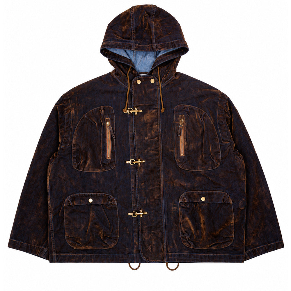 Front flat lay studio view of the Brain Dead Flocked Denim Fireman Jacket, showcasing a heavy workwear-inspired hooded jacket crafted from indigo blue denim treated with an all-over textured brown velvet flocking, featuring a high collar with dual brass snaps, protective storm hood with adjustable drawstrings, concealed front zipper secured by three heavy-duty antique brass fireman clip closures, two arched vertical zipper chest pockets, two lower flap pockets with snap fastenings, and an adjustable cinchab