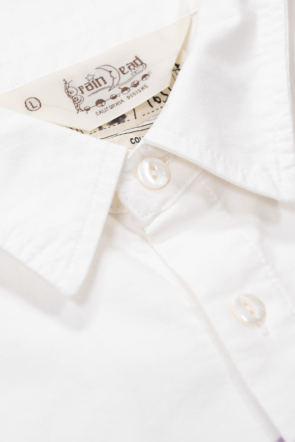 Brain Dead Gaspar Heart Oxford Button Up Shirt White, Los Angeles streetwear piece showcasing Ema Gaspar’s unique illustrated artwork.