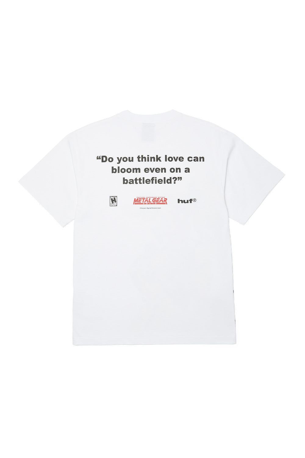 Back view of HUF x Metal Gear Solid white T-shirt showing “Do you think love can bloom even on a battlefield?” quote with official Konami and HUF logos