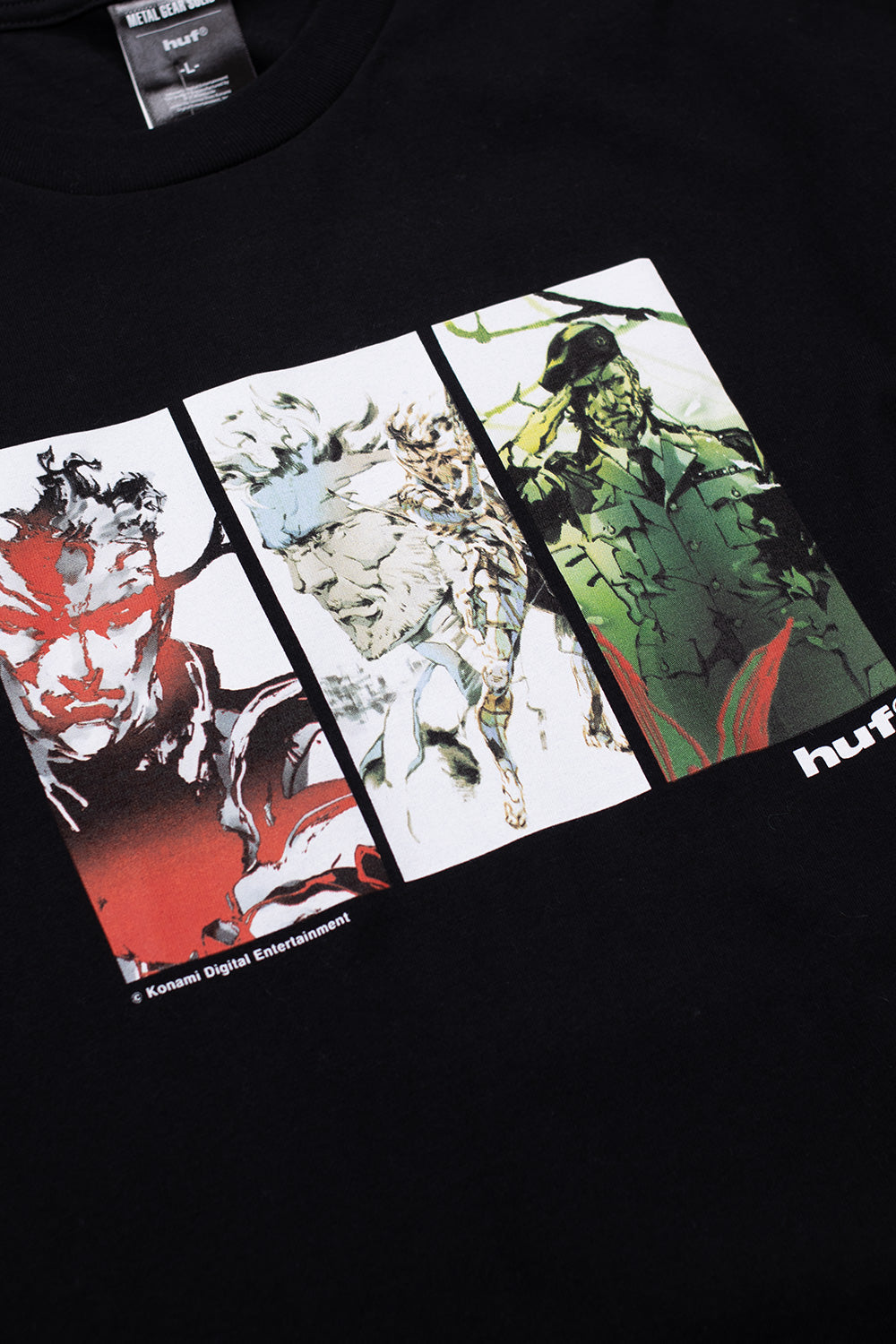 Close-up of front chest artwork on HUF x Metal Gear Solid Legacy T-shirt showing Solid Snake inspired illustration, archival Japanese game art and bold streetwear graphics