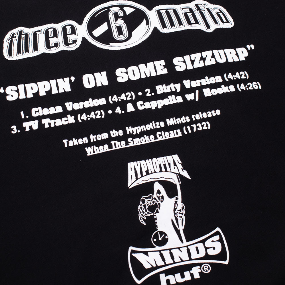 Angled close-up shot of the back graphics on the Huf X Three 6 Mafia Heavyweight Hoodie, detailing the stark white printed cassette single typography for "SIPPIN' ON SOME SIZZURP", listing song versions, production release credits for Hypnotize Minds, and the scythe-wielding grim reaper graphic holding a clock.
