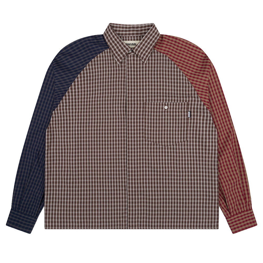 Front flat lay studio view of the Metalwood Studio Frankenstein Button Up Shirt, showcasing an asymmetrical colorblock long sleeve collared shirt with a brown micro-plaid body, navy blue check right raglan sleeve, burgundy red plaid left raglan sleeve, hidden front button placket, and a buttoned left chest patch pocket with a woven black logo tab.