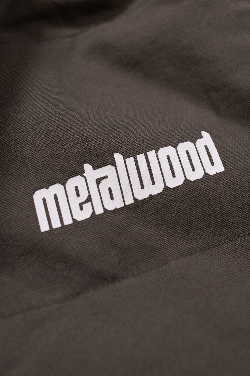 Versatile Metalwood Studio reversible vest in fatigue green, offering a stylish and practical solution for layering.