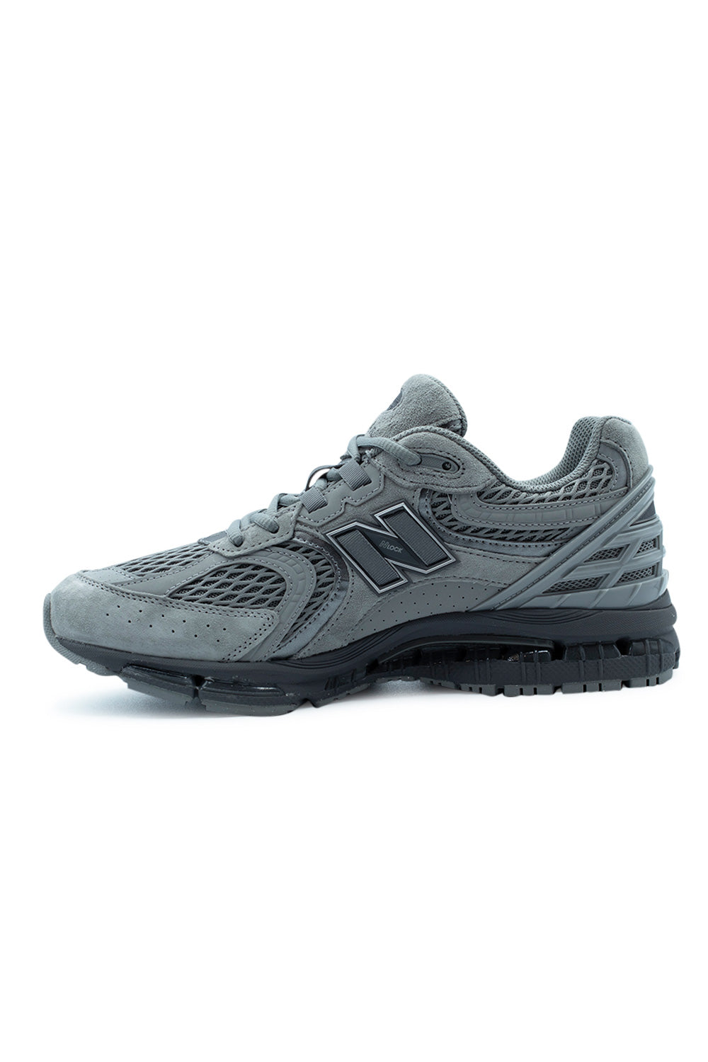 Medial side view of the New Balance 1954R sneaker, detailing the grey suede panels, structural synthetic overlays, and the sculpted black midsole.