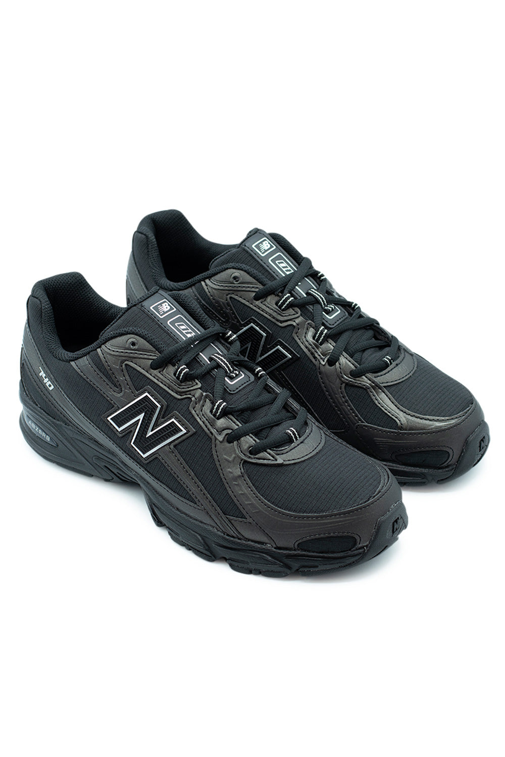 Side view of unisex New Balance 740 Shoe in Black and Silver Metallic featuring molded TPU N logo and lightweight ripstop construction.