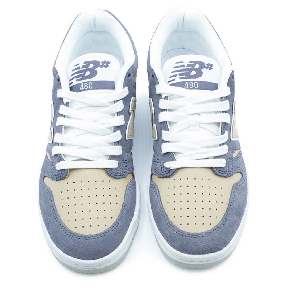 Top-down studio view of the New Balance Numeric 480 shoes, displaying the perforated incense beige leather toe boxes, meteorite blue suede mudguards and eyestays, flat white cotton laces over padded breathable mesh tongues, and woven tongue tags featuring the NB# 480 branding in slate blue and white.