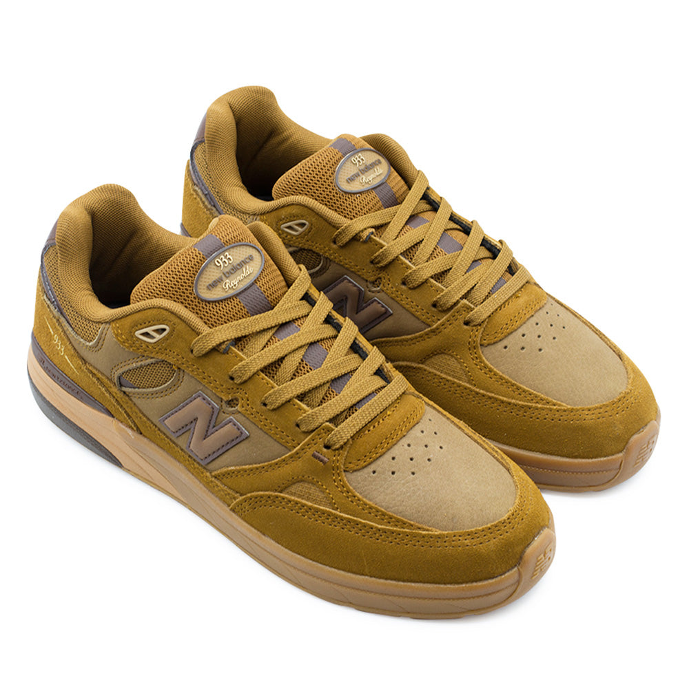 Pair angle studio presentation of the New Balance Numeric Andrew Reynolds 933 sneakers in Breakfast Tea and Pumpernickel, emphasizing the early-2000s runner-inspired silhouette engineered with reinforced suede skate ollie guards, full-grain leather side underlays, and padded collars.