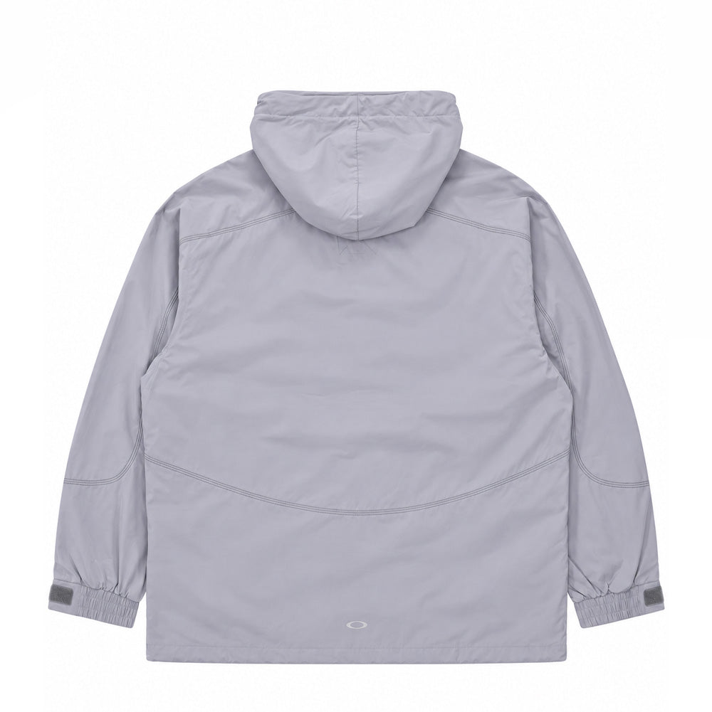 Back flat lay studio perspective of the light grey Oakley FGL Sector Jacket 6.7, displaying the panelled protective hood, curved ergonomic back yoke with contrast stitching, articulated sleeve elbows with velcro wrist adjustments, and a subtle reflective silver heat-sealed Oakley Ellipse logo centered along the bottom hem.