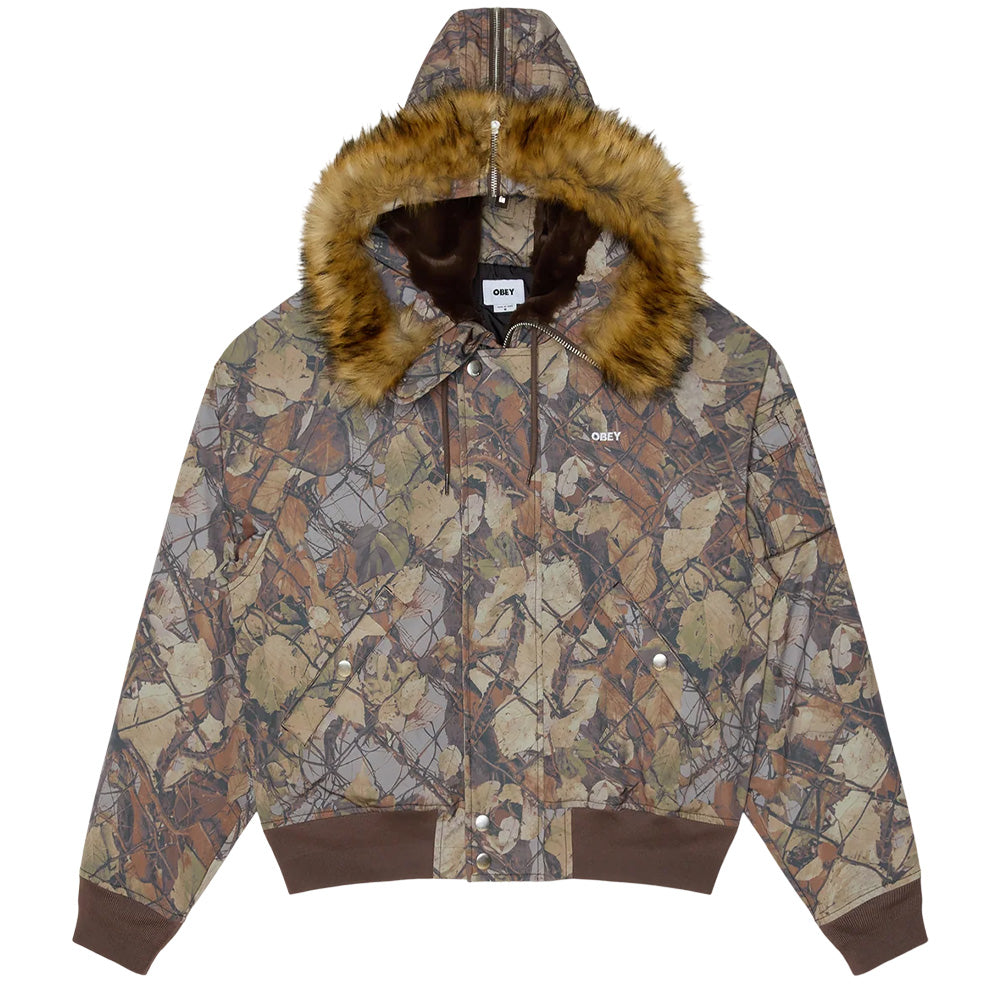 Front flat lay view of the Obey N-2B Short Parka in Fence Camo, showcasing an allover photorealistic fallen leaves and wire-fence realtree camouflage shell, insulated quilting, a full zip front closure with snap storm flap, slanted snap hand pockets, wide brown rib-knit waistband and cuffs, an embroidered white OBEY logo on the left chest, and an oversized snorkel hood lined with plush brown faux fur and a fuzzy faux-fur trim.
