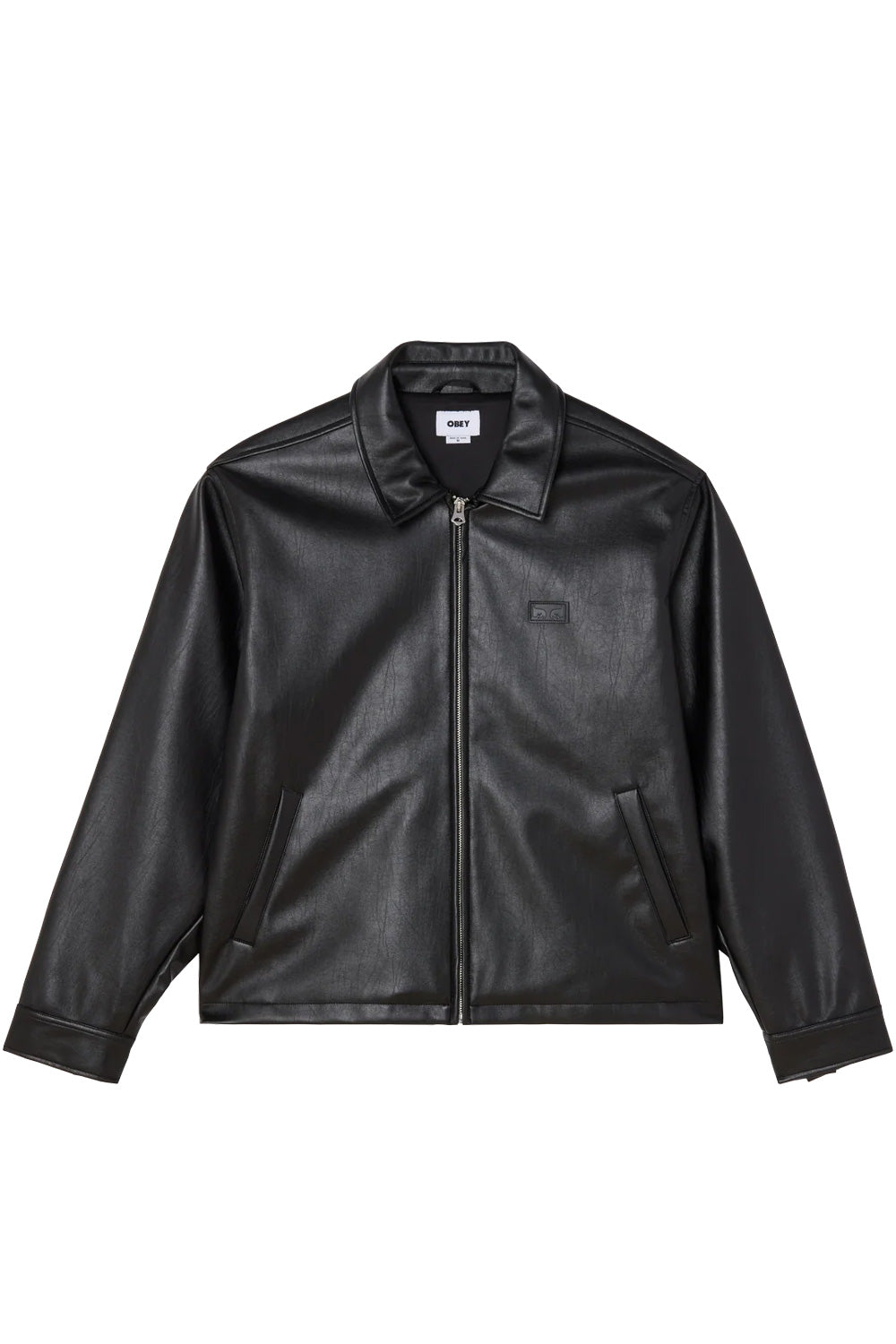 Front view of the black Obey Workman PU Jacket, constructed from textured black polyurethane faux leather in a boxy workwear fit, featuring a pointed turn-down collar, full-length silver front zipper, angled side welt pockets, and an embossed black Obey Eyes logo patch on the left chest.
