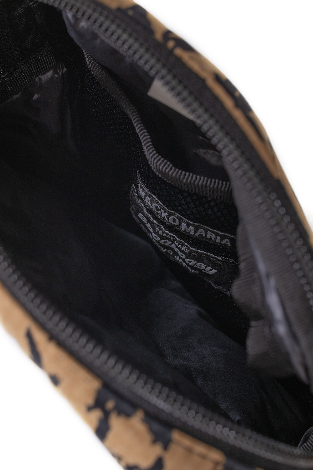 Inside view Wacko Maria Speak Easy small shoulder bag showing mesh pocket and YKK zip compartments, durable polyester lining compact Japanese designer crossbody
