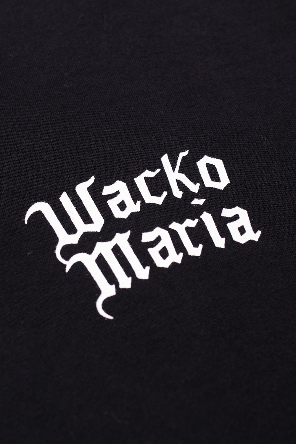 Wacko Maria chest logo detail on washed black crew neck t-shirt, minimalist front print on wide fit luxury streetwear essential