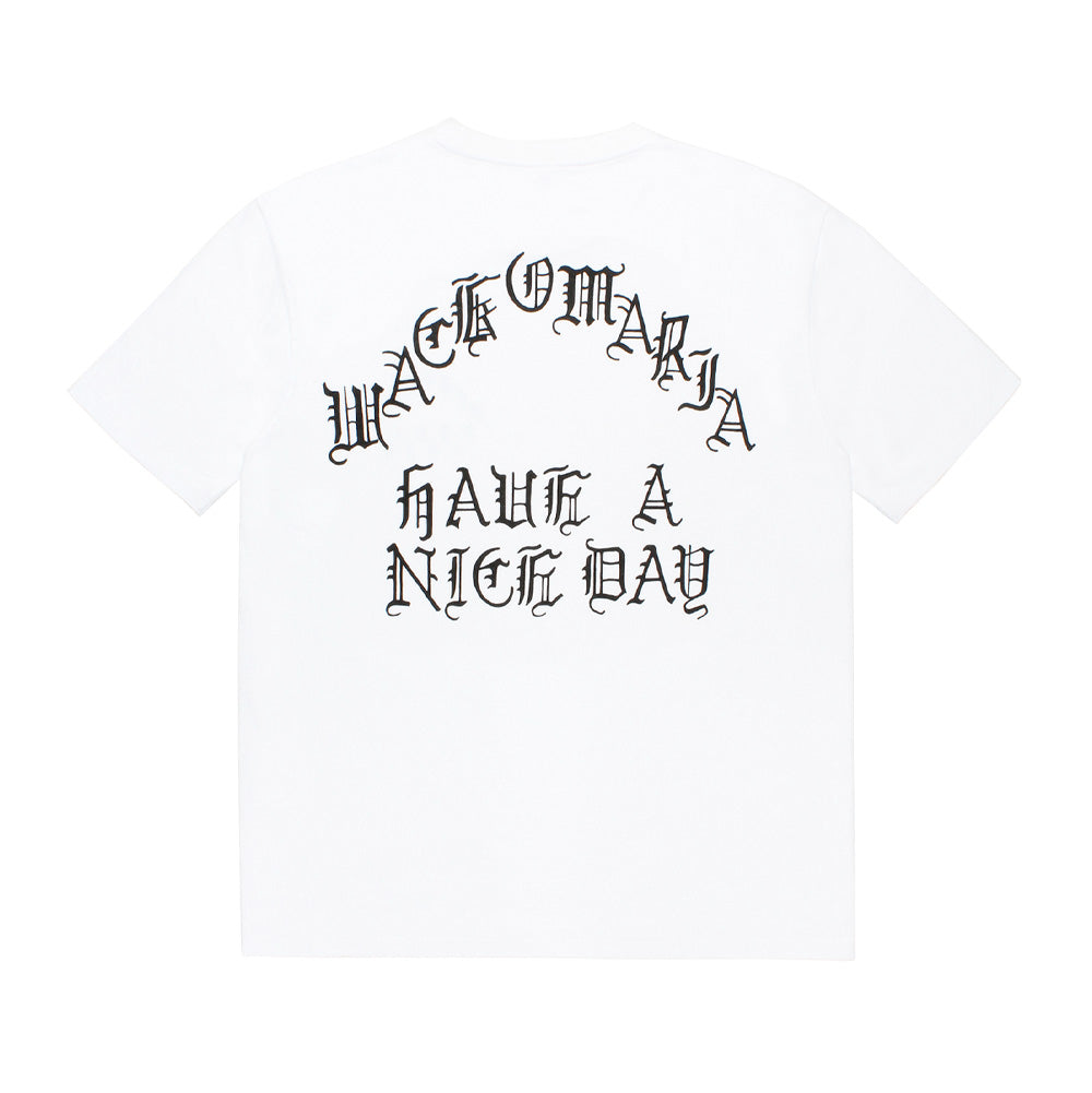 Back studio flat lay view of the Wacko Maria Washed Heavy Weight Crew Neck T-Shirt Type 2 in optic white, showcasing the relaxed streetwear silhouette, ribbed crew collar, straight hem, and centered black screen print in stylized Old English gothic typography reading "WACKO MARIA" over "HAVE A NICE DAY".