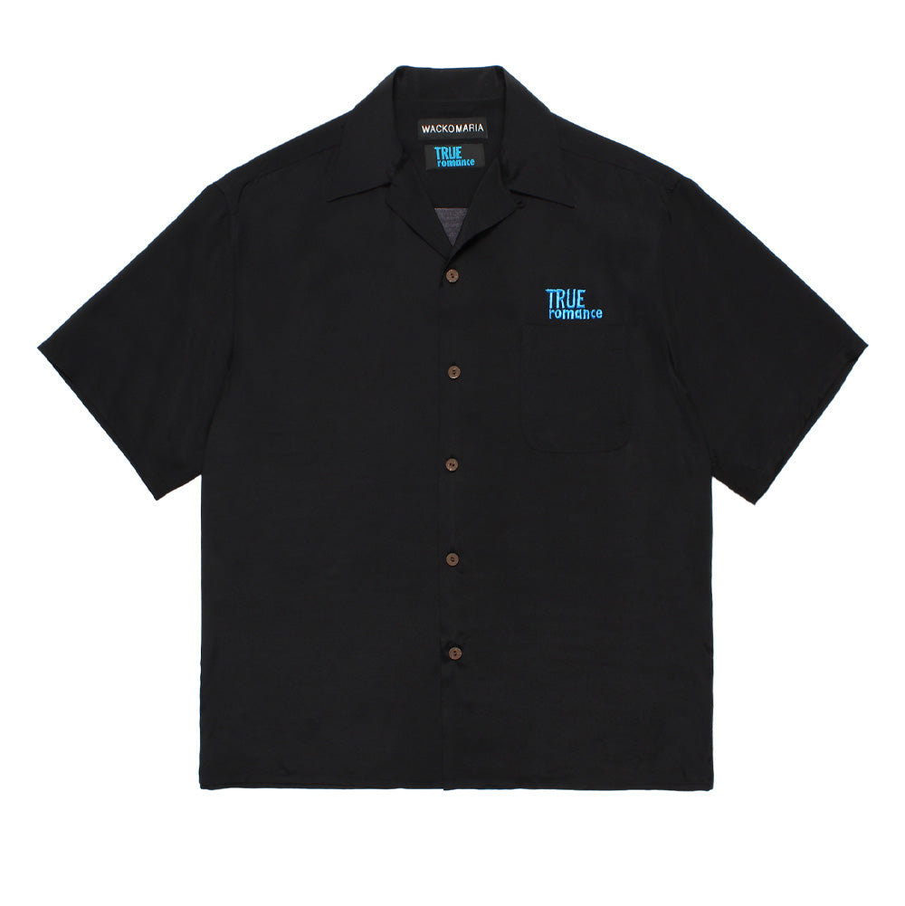 Front flat lay studio view of the black Wacko Maria x True Romance Short Sleeve Hawaiian Shirt, featuring a relaxed boxy cut, open Cuban collar, brown wood-effect buttons down the placket, a single patch pocket on the left chest, and turquoise-blue embroidered "TRUE ROMANCE" script.