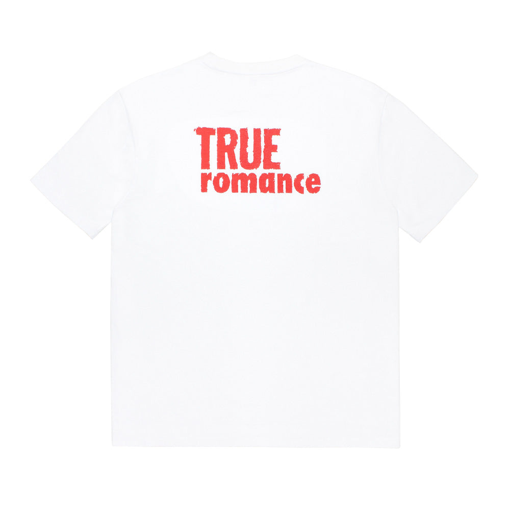 Back flat lay studio view of the white Wacko Maria x True Romance Washed Heavy Weight T-Shirt, displaying the clean drop-shoulder seams, straight bottom hem, and upper back distressed stencil-style graphic print spelling out "TRUE ROMANCE" in bold red text.